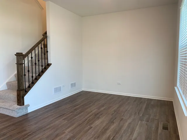 a view of a hallway with wooden floor and entryway