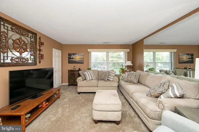 a living room with furniture flat screen tv and a fireplace