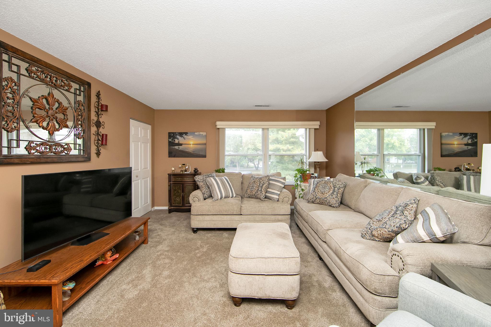 a living room with furniture flat screen tv and a fireplace