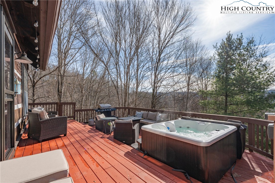 419 Billy Billings Road Vilas, NC 28692 - Photo 13 of 50 a view of a roof deck with couches and wooden fence