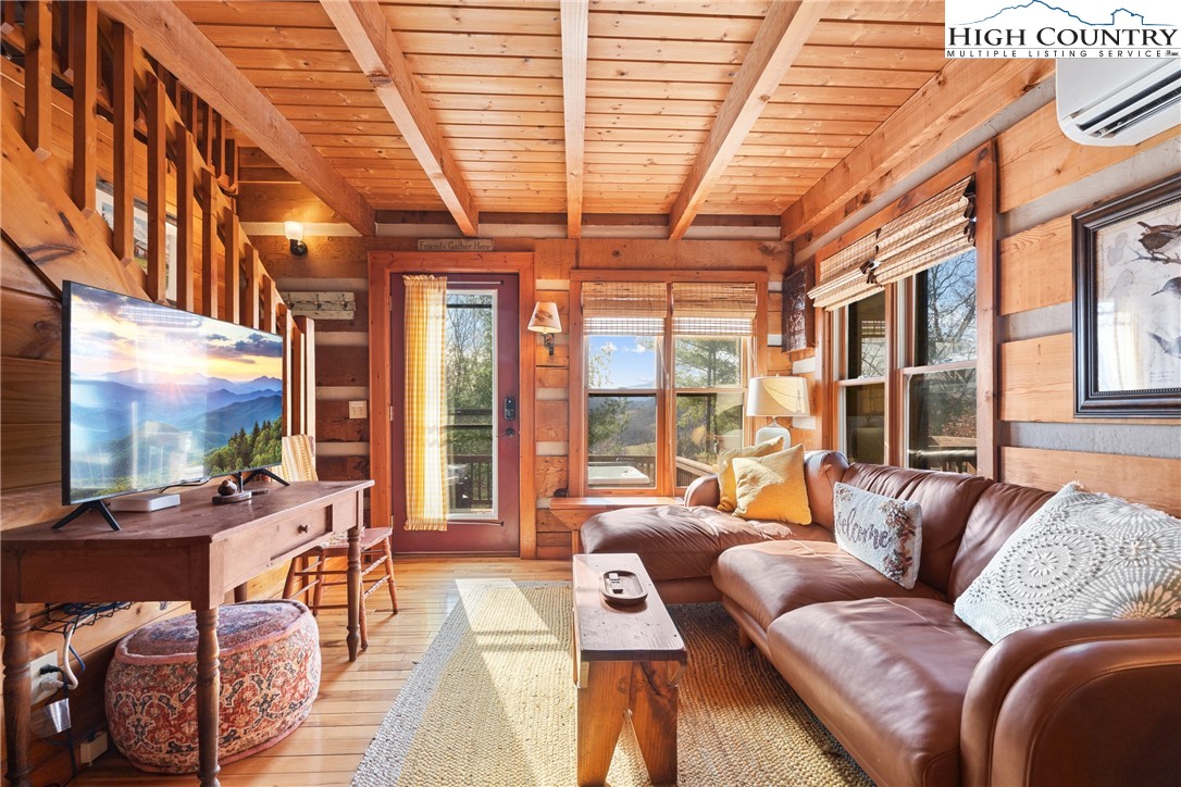 419 Billy Billings Road Vilas, NC 28692 - Photo 17 of 50 a living room with furniture a flat screen tv and a large window