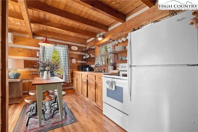 a bedroom with a bed and a large window with outer view