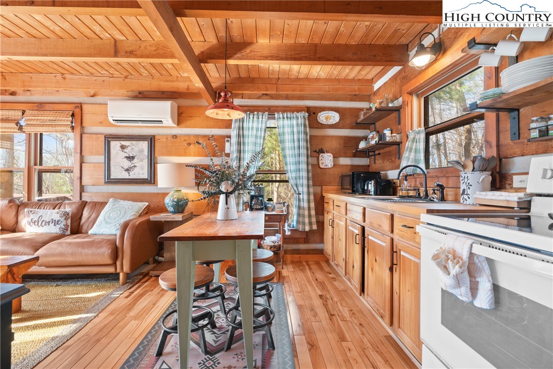 419 Billy Billings Road Vilas, NC 28692 - Photo 21 of 50 a living room with fireplace furniture and a large window