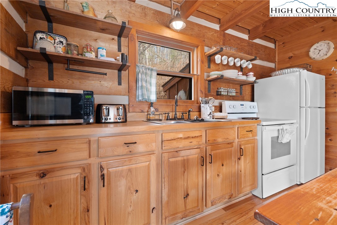419 Billy Billings Road Vilas, NC 28692 - Photo 22 of 50 a kitchen with stainless steel appliances white cabinets and a refrigerator