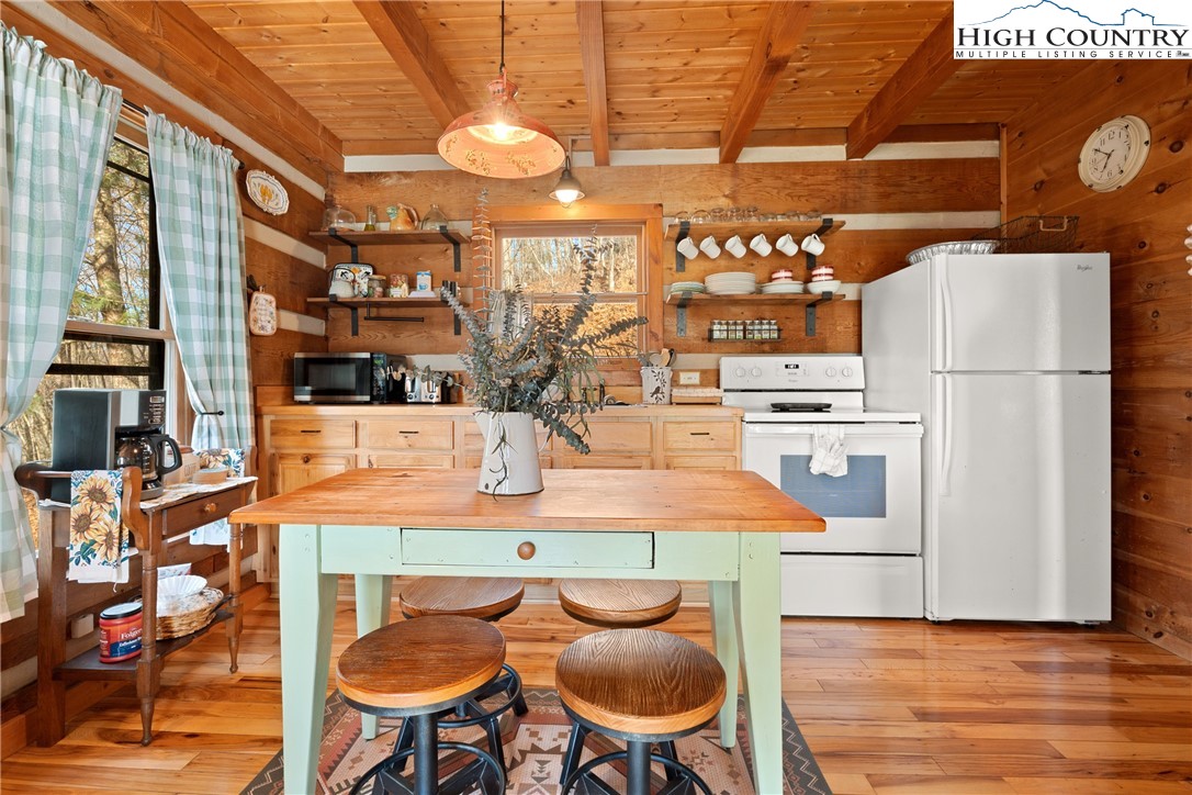 419 Billy Billings Road Vilas, NC 28692 - Photo 23 of 50 a kitchen with stainless steel appliances kitchen island granite countertop a table chairs and a refrigerator