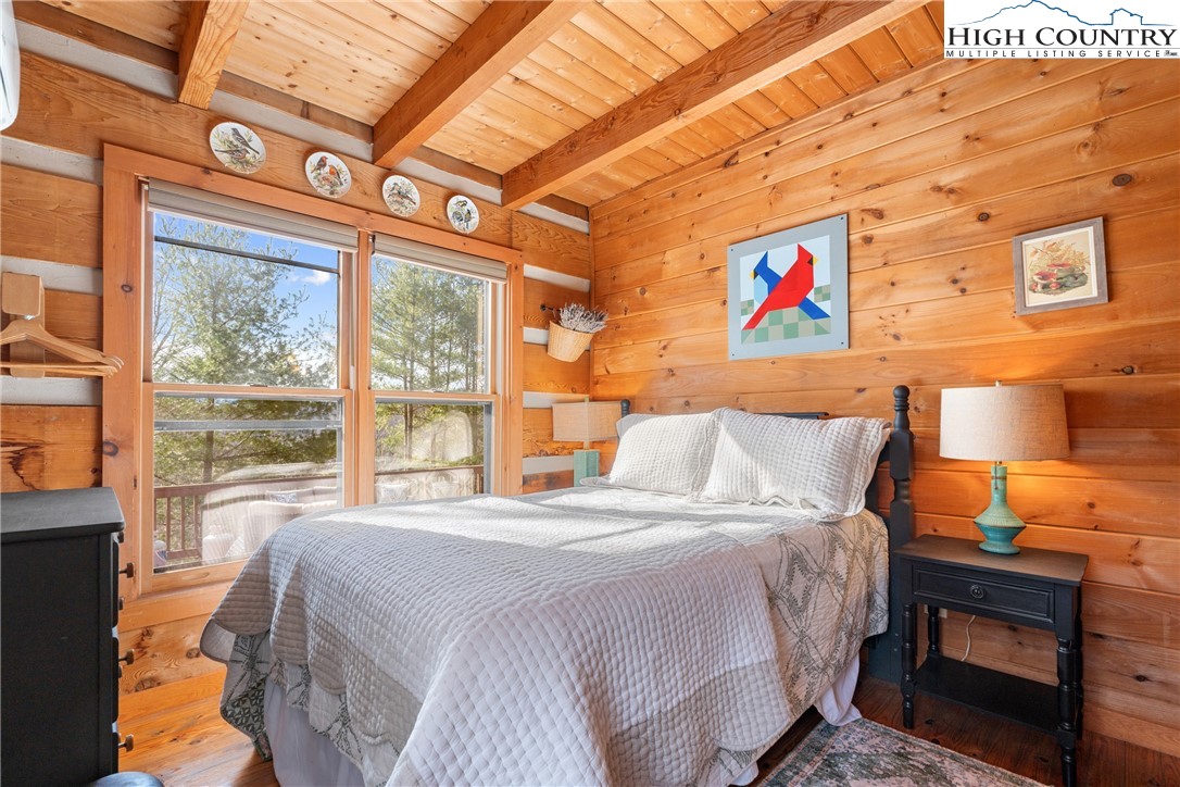 419 Billy Billings Road Vilas, NC 28692 - Photo 26 of 50 a bedroom with a bed next to a window