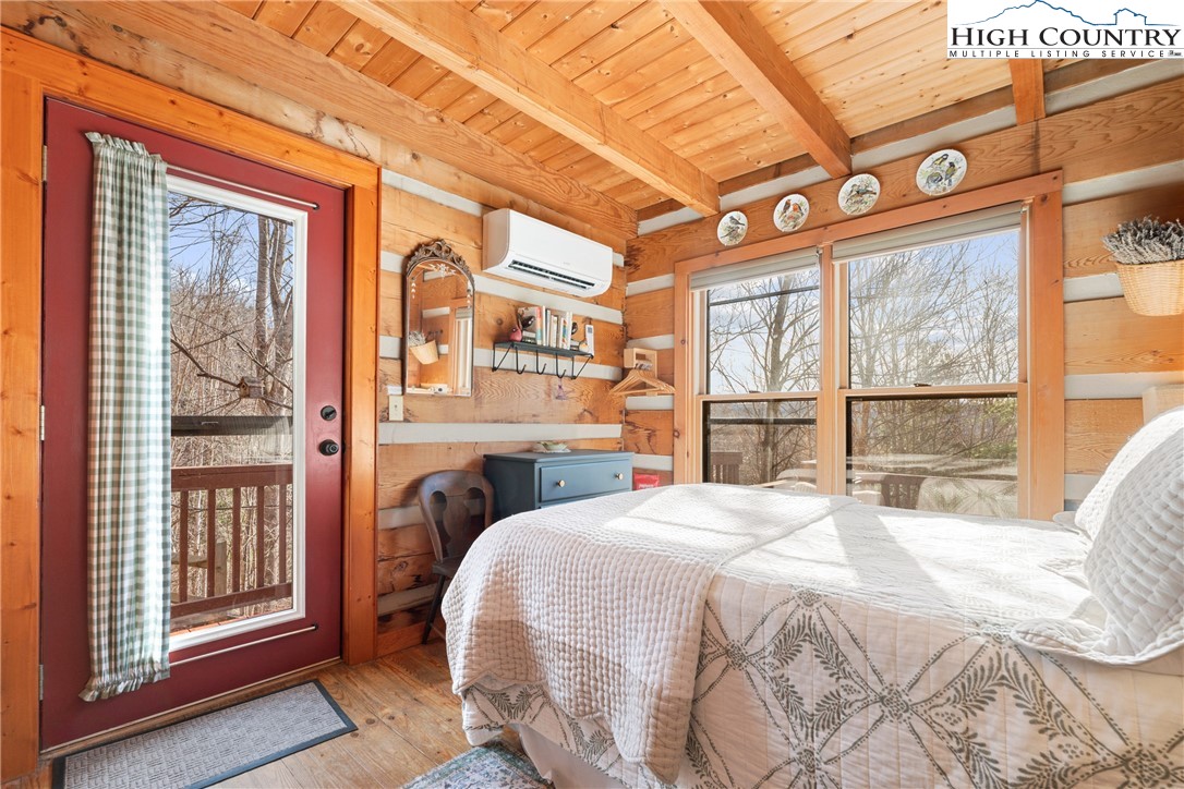 419 Billy Billings Road Vilas, NC 28692 - Photo 28 of 50 a bedroom with a bed and a large window with outer view