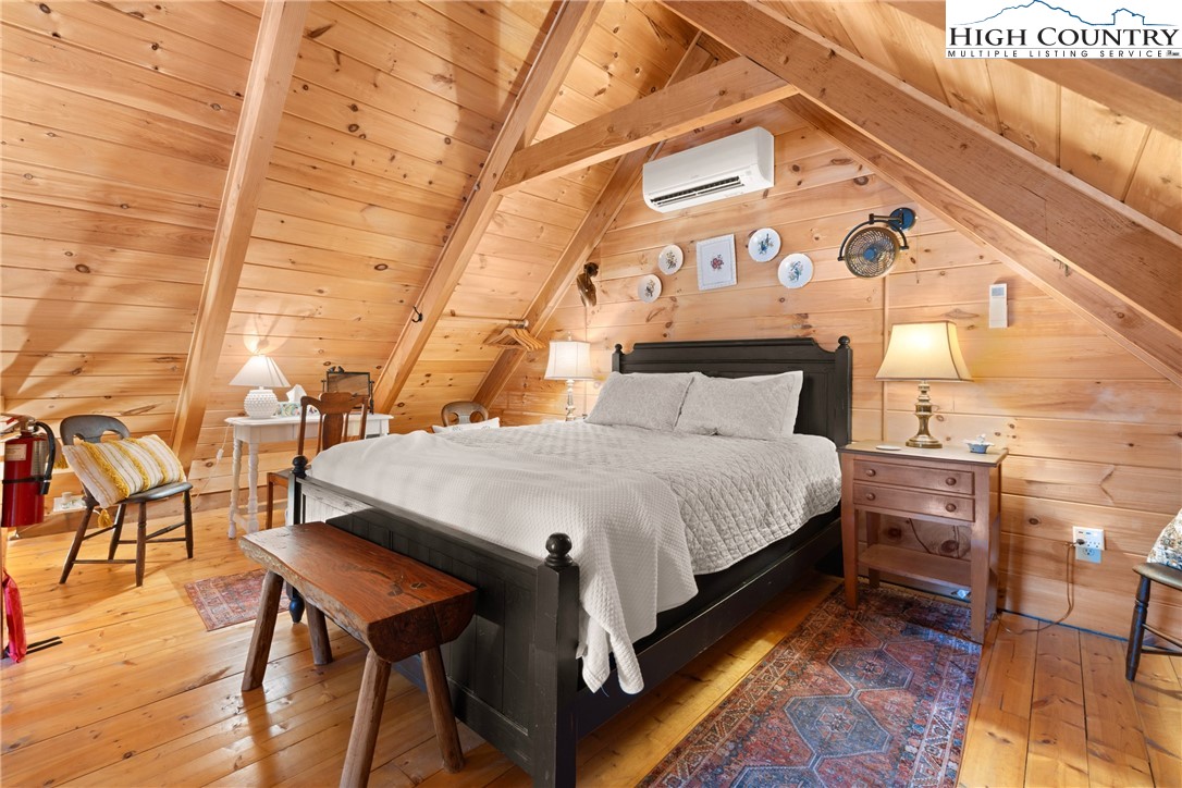 419 Billy Billings Road Vilas, NC 28692 - Photo 30 of 50 a bed sitting in a bedroom next to a building