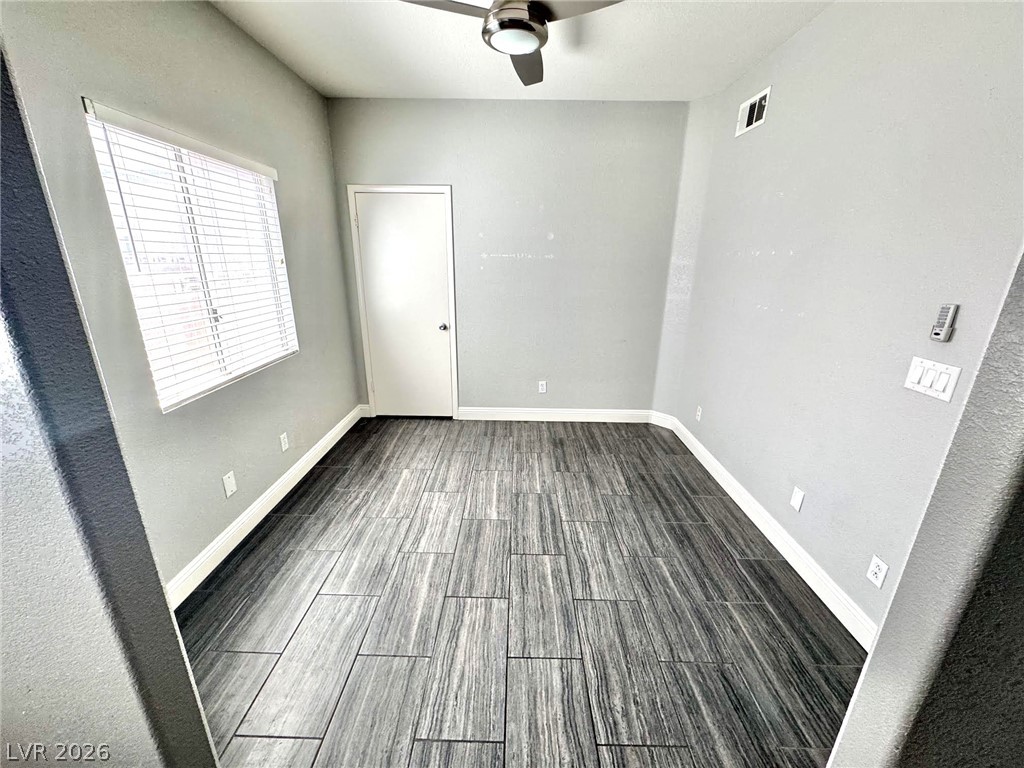 5304 Runningbrook Road Las Vegas, NV 89120 - Photo 4 of 22 Modern wood-look plank flooring complements this versatile room illuminated by natural light.