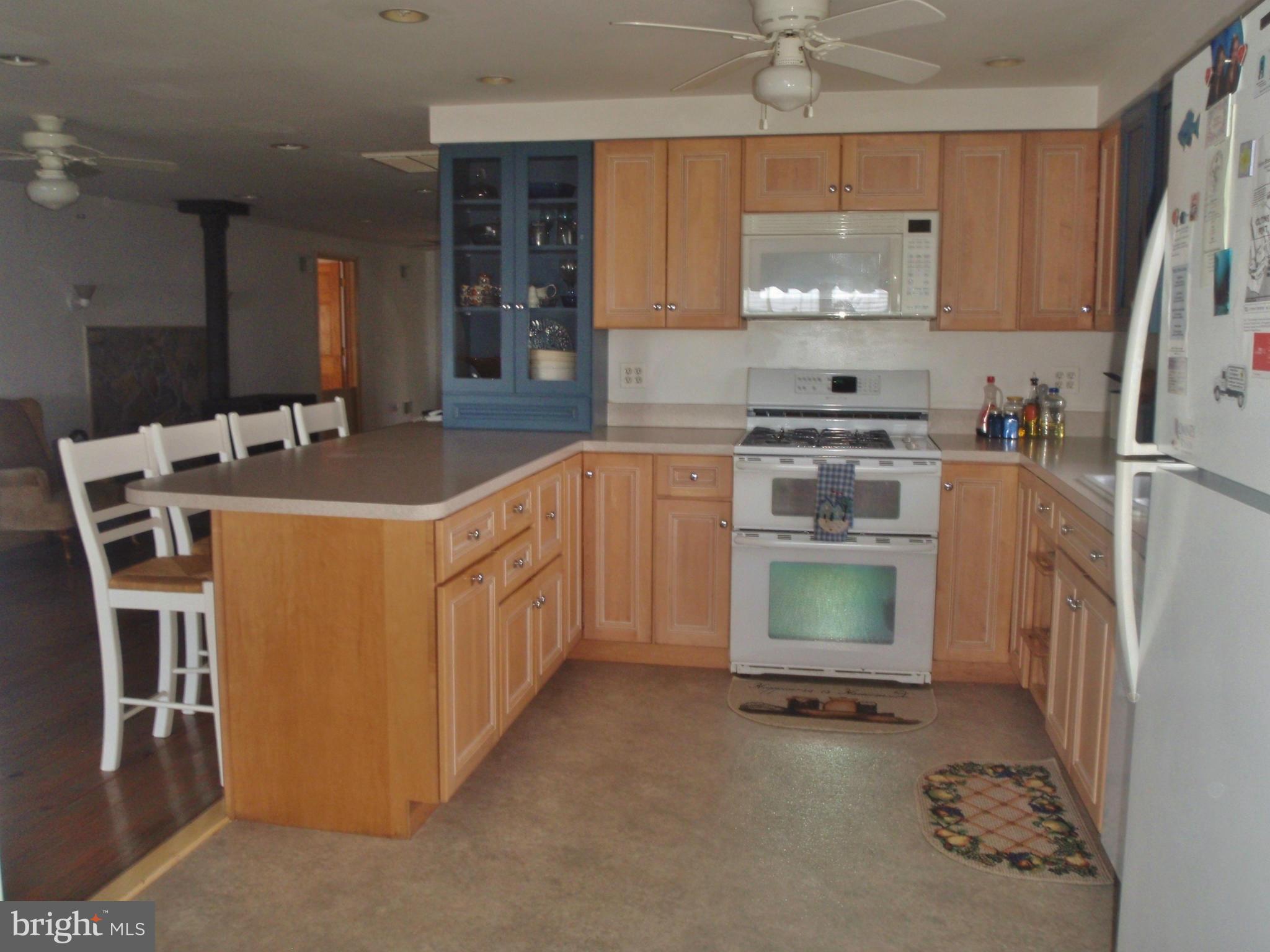 38431 Bayview Road Coltons Point, MD 20626 - Photo 5 of 25 a kitchen with stainless steel appliances a stove a sink and a refrigerator