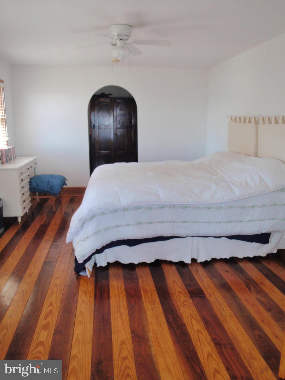 38431 Bayview Road Coltons Point, MD 20626 - Photo 9 of 25 a bedroom with a bed and wooden floor