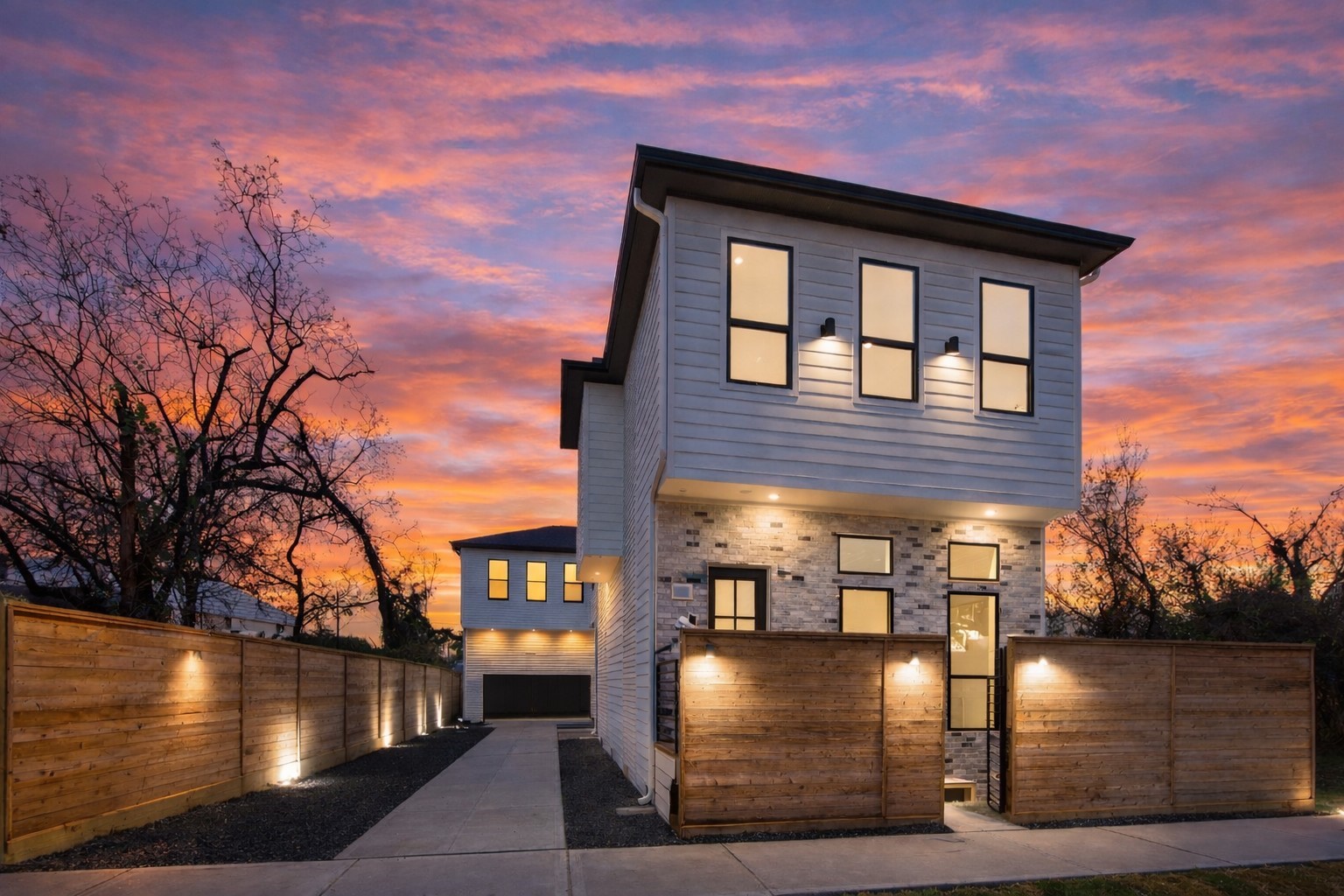 602 Jewett Street, Unit B Houston, TX 77009 - Photo 2 of 38 Modern two-story home with a contemporary exterior, wood accents, and an abundance of windows. The property features a fenced yard.