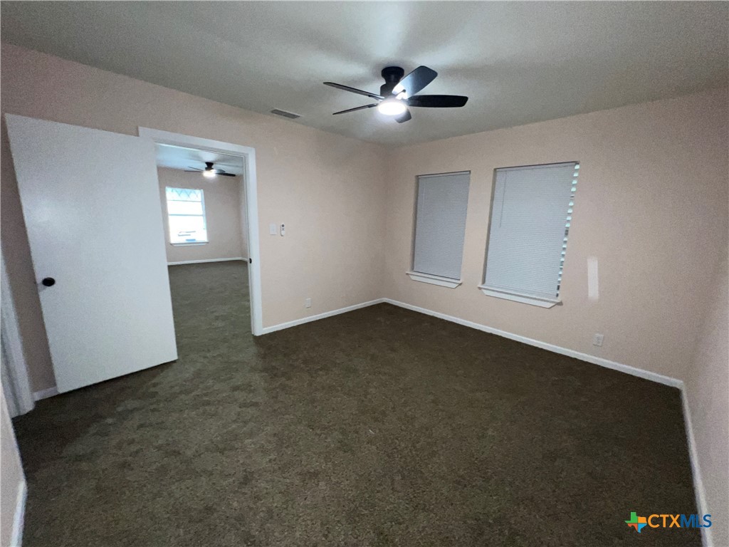 1009 Oak Street Refugio, TX 78377 - Photo 2 of 22 an empty room with a empty space and windows