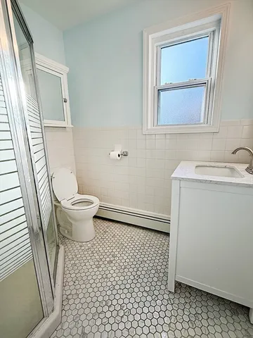 a view of a patio with a table and chairs and a barbeque