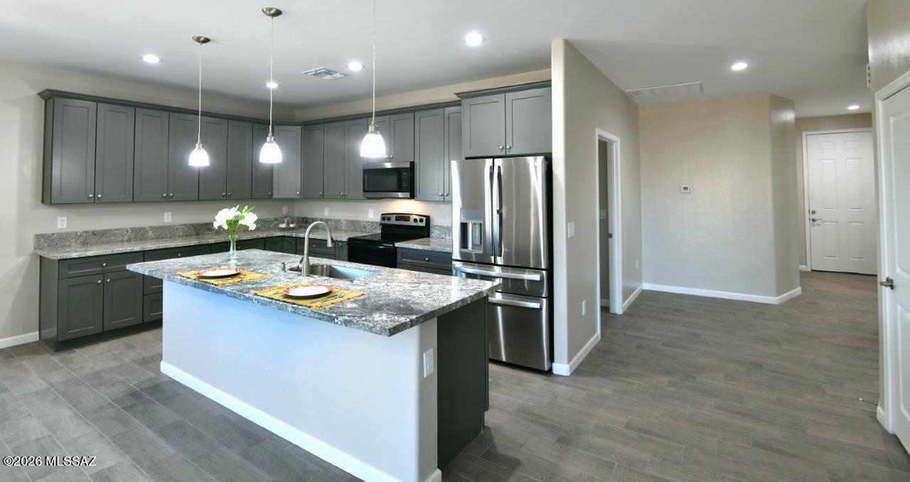 1091 North Vail View Road Vail, AZ 85641 - Photo 2 of 43 a kitchen with kitchen island stainless steel appliances a sink stove and refrigerator