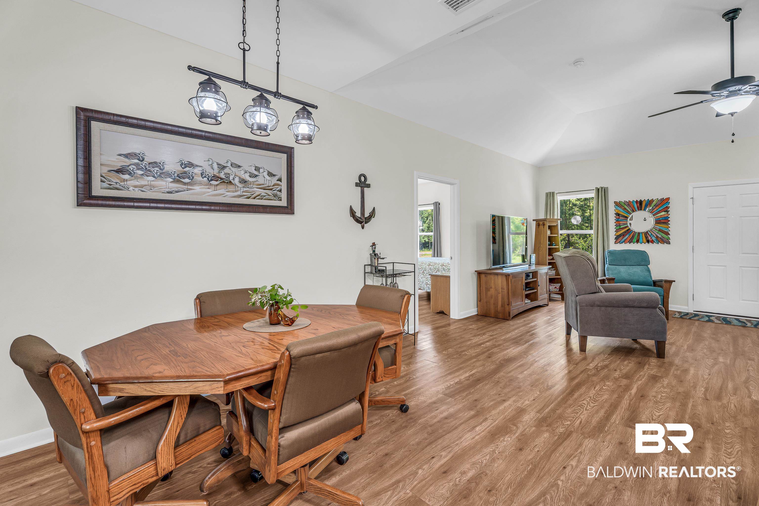 18255 Cactus Court Elberta, AL 36530 - Photo 15 of 53 Dining space featuring wood finished floors, a ceiling fan, and vaulted ceiling