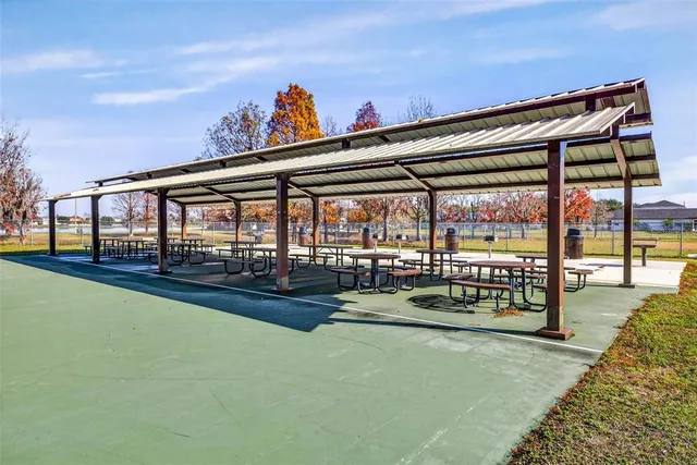a view of a lake with a yard and large trees