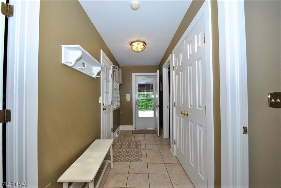 Wide Hallway From Garage Leads To Office, Laundry Room, Full Bath, Coat Closet & Walk-in Pantry