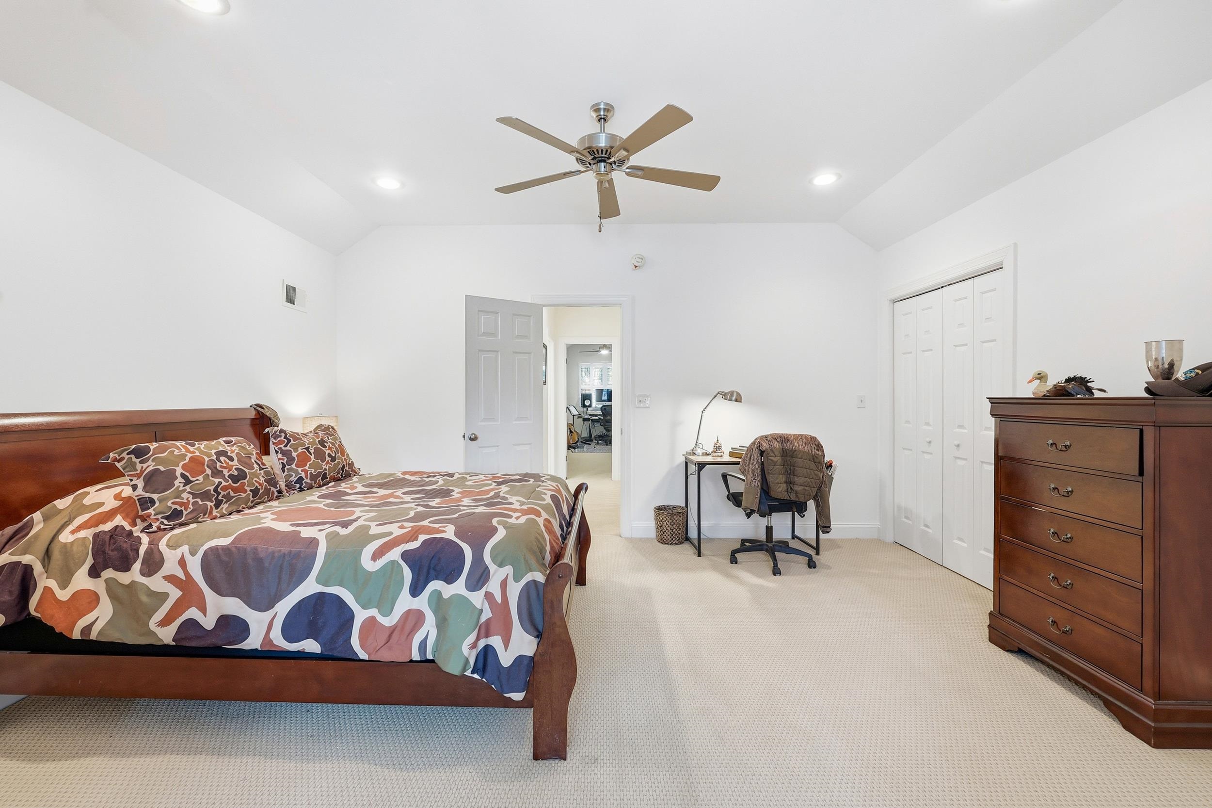 213 Old Carriage Loop Georgetown, SC 29440 - Photo 30 of 40 Bedroom featuring vaulted ceiling, carpet, ceiling fan, a desk, and a closet