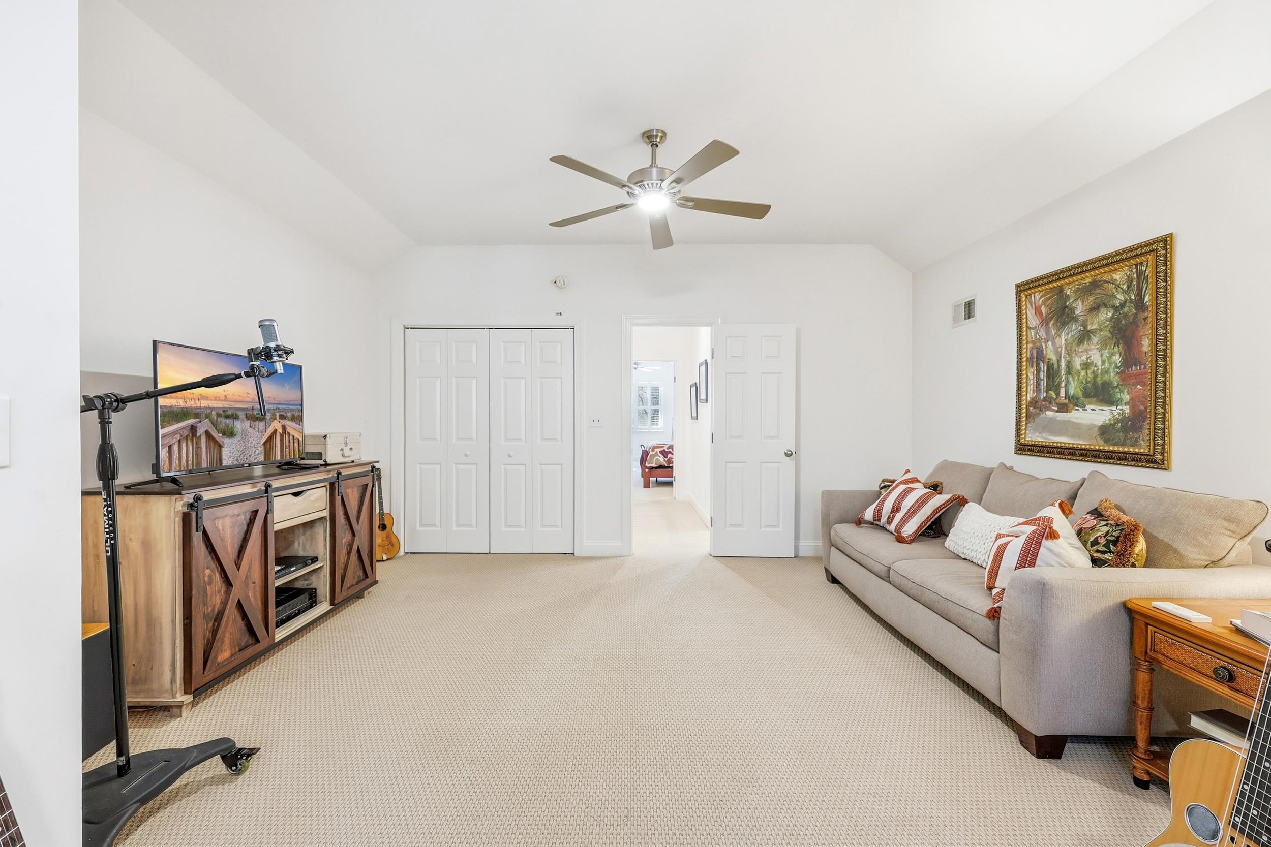 213 Old Carriage Loop Georgetown, SC 29440 - Photo 33 of 40 Living area with vaulted ceiling, light carpet, and ceiling fan