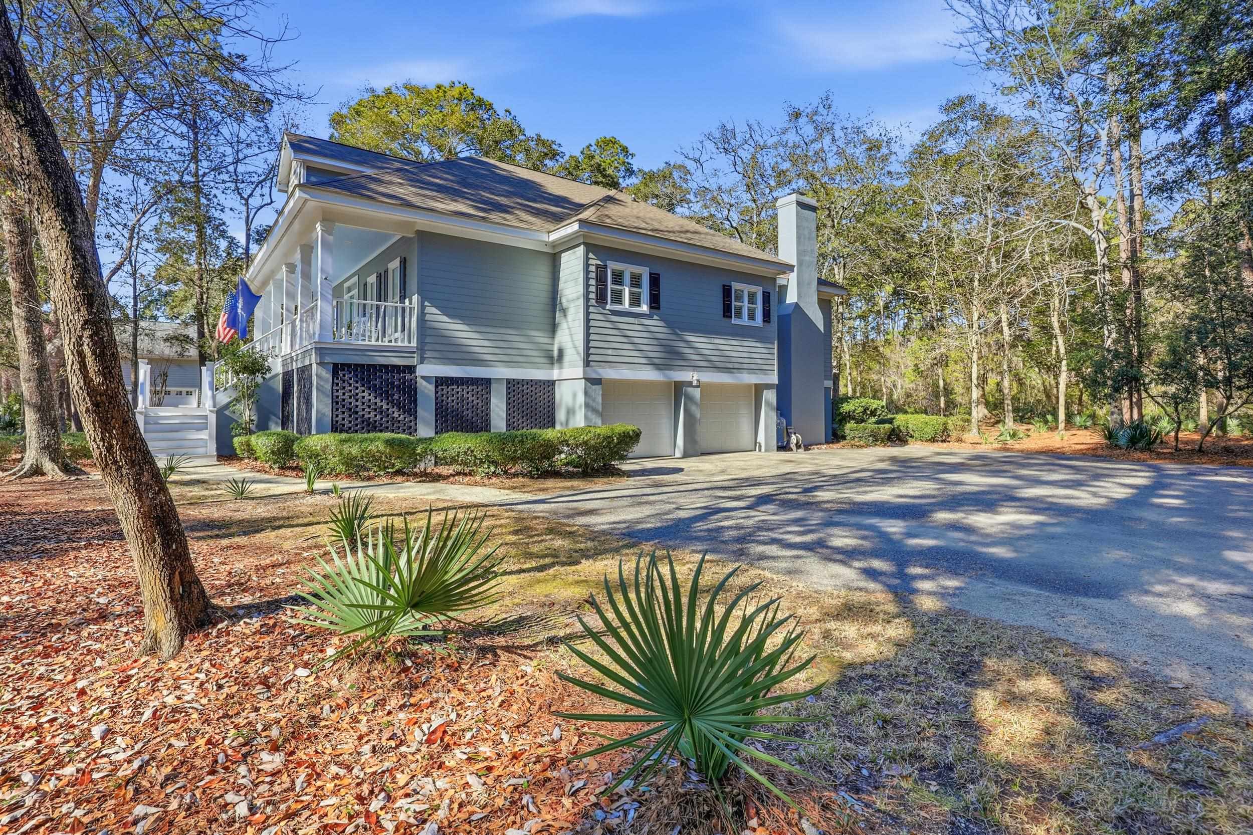 213 Old Carriage Loop Georgetown, SC 29440 - Photo 38 of 40 View of home's exterior featuring a chimney, an attached garage, asphalt driveway, and a balcony