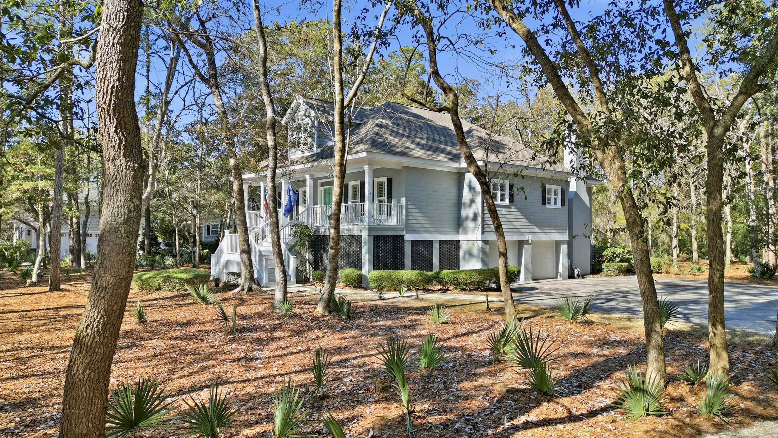213 Old Carriage Loop Georgetown, SC 29440 - Photo 40 of 40 View of front of house with stairs, driveway, a garage, and a balcony