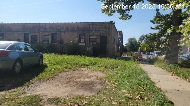 a view of a house with a backyard and pathway
