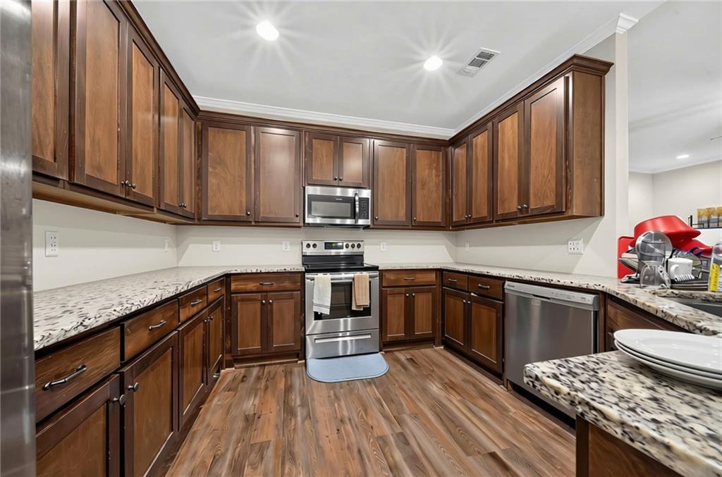 5 Fast Lane Seale, AL 36875 - Photo 7 of 13 Chef's kitchen featuring rich wood cabinetry, stainless steel appliances, and speckled stone countertops