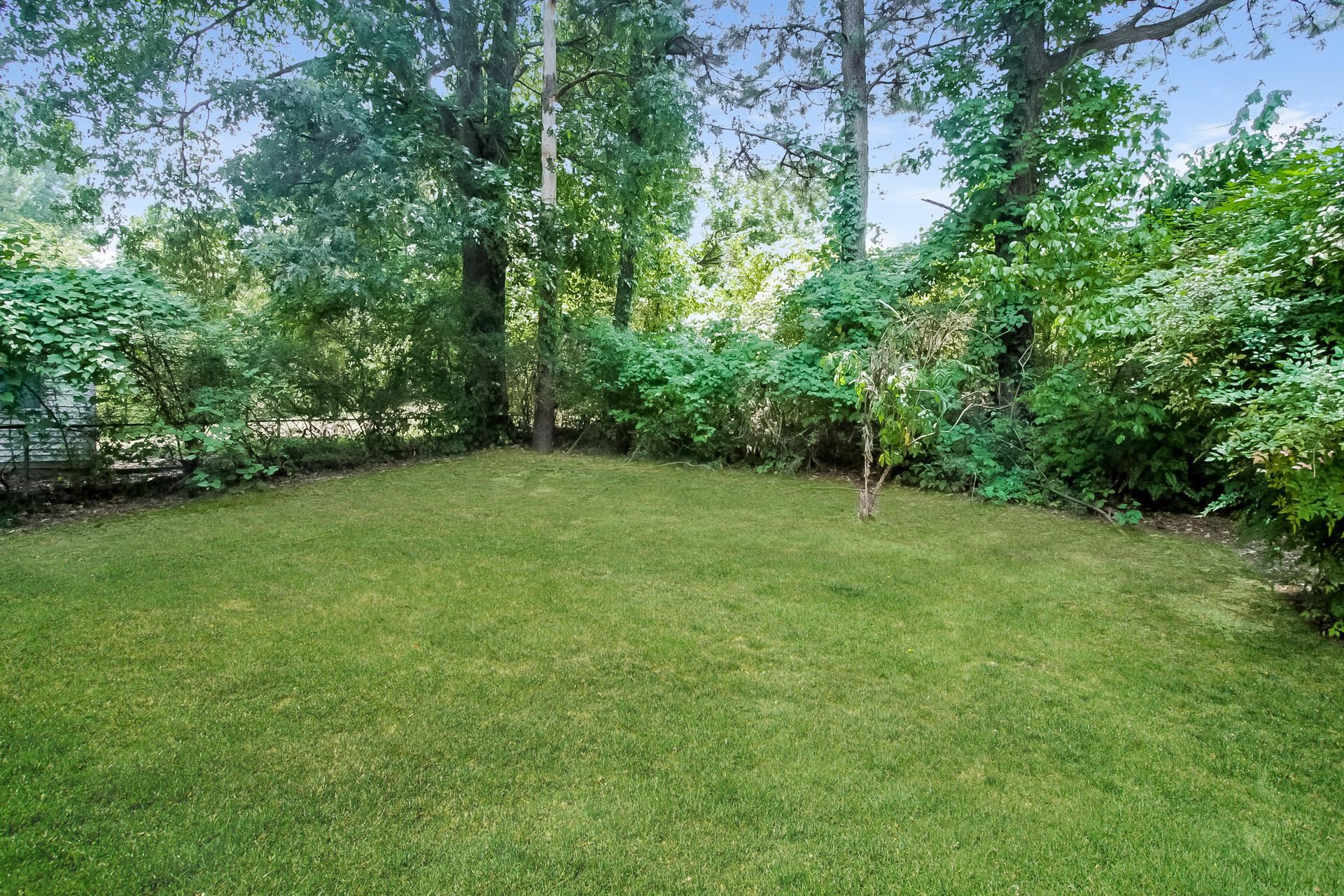4217 Windermere Road Memphis, TN 38128 - Photo 14 of 15 a view of a green yard with large trees