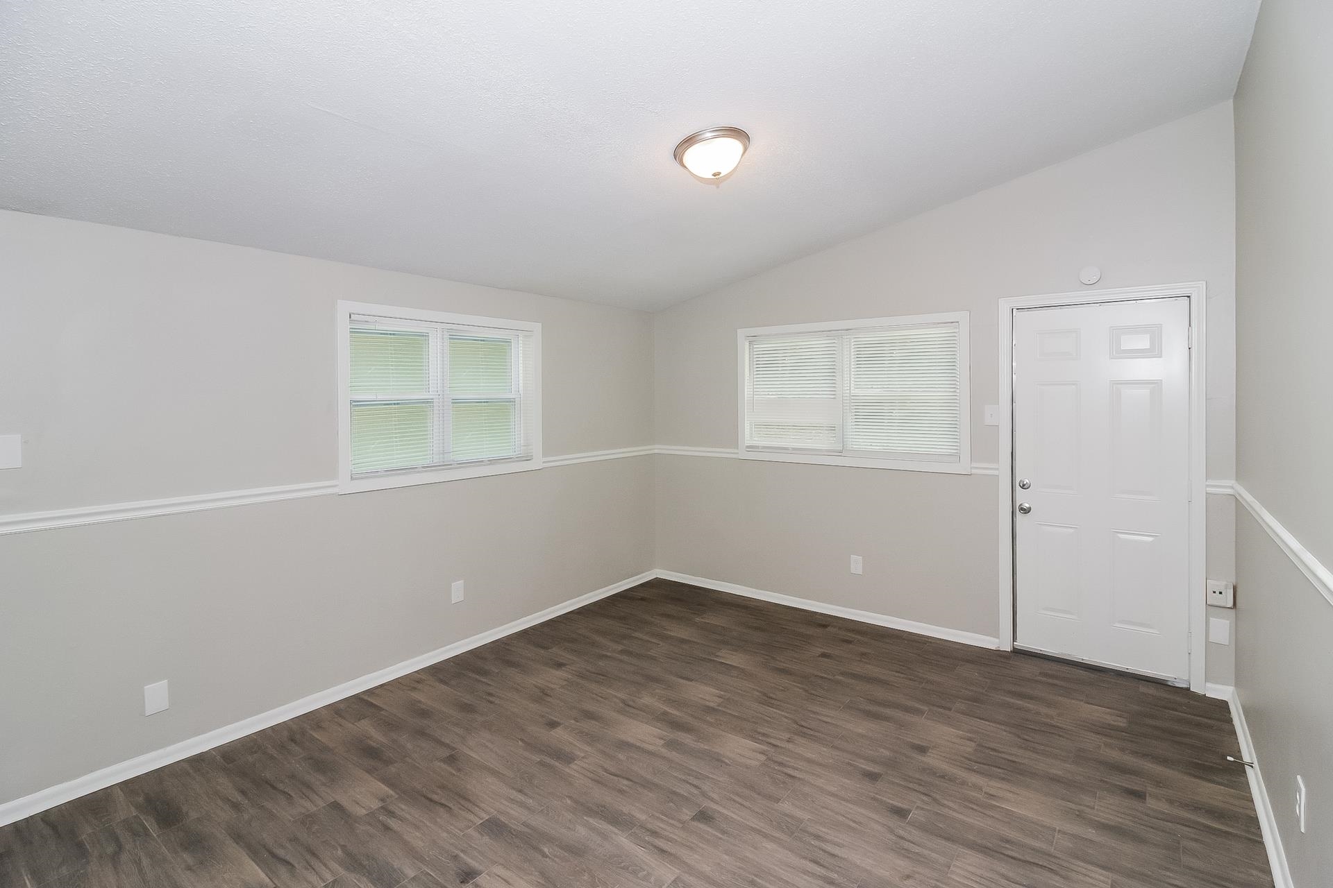 4217 Windermere Road Memphis, TN 38128 - Photo 2 of 15 an empty room with wooden floor and windows