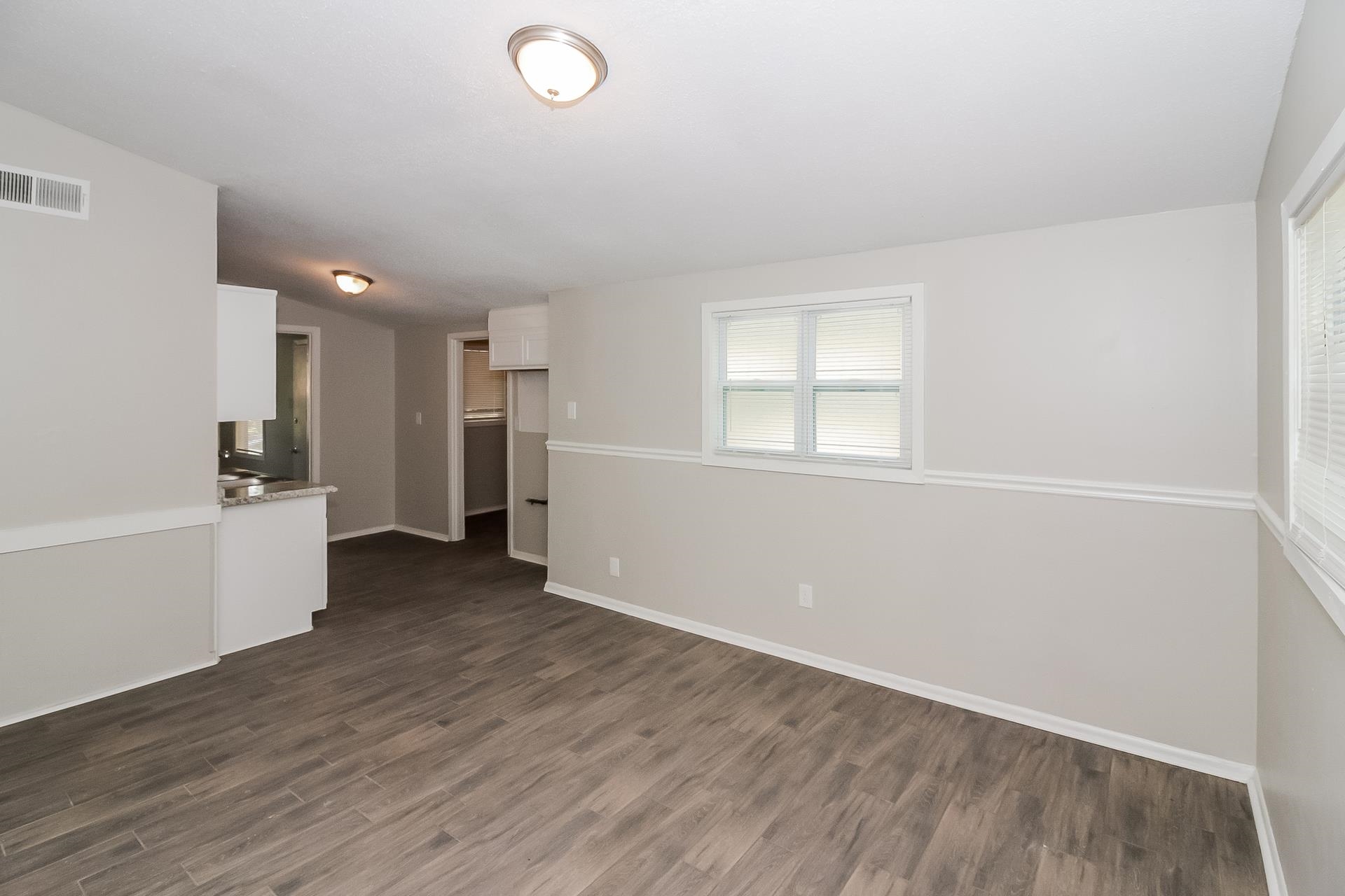 4217 Windermere Road Memphis, TN 38128 - Photo 4 of 15 an empty room with wooden floor and windows