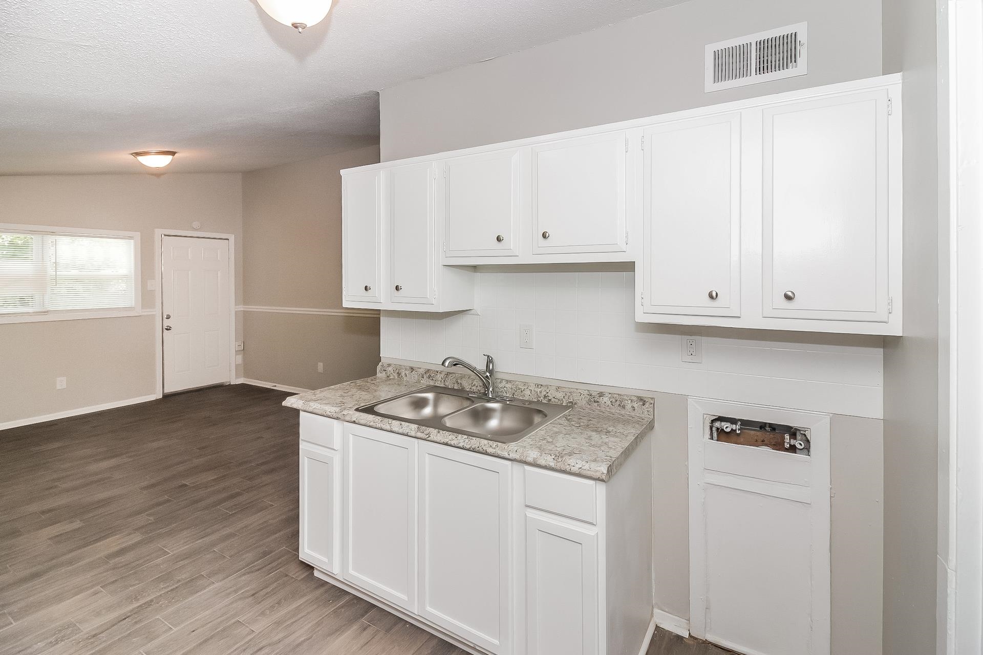 4217 Windermere Road Memphis, TN 38128 - Photo 5 of 15 a kitchen with stainless steel appliances granite countertop a sink stove and cabinets with wooden floor