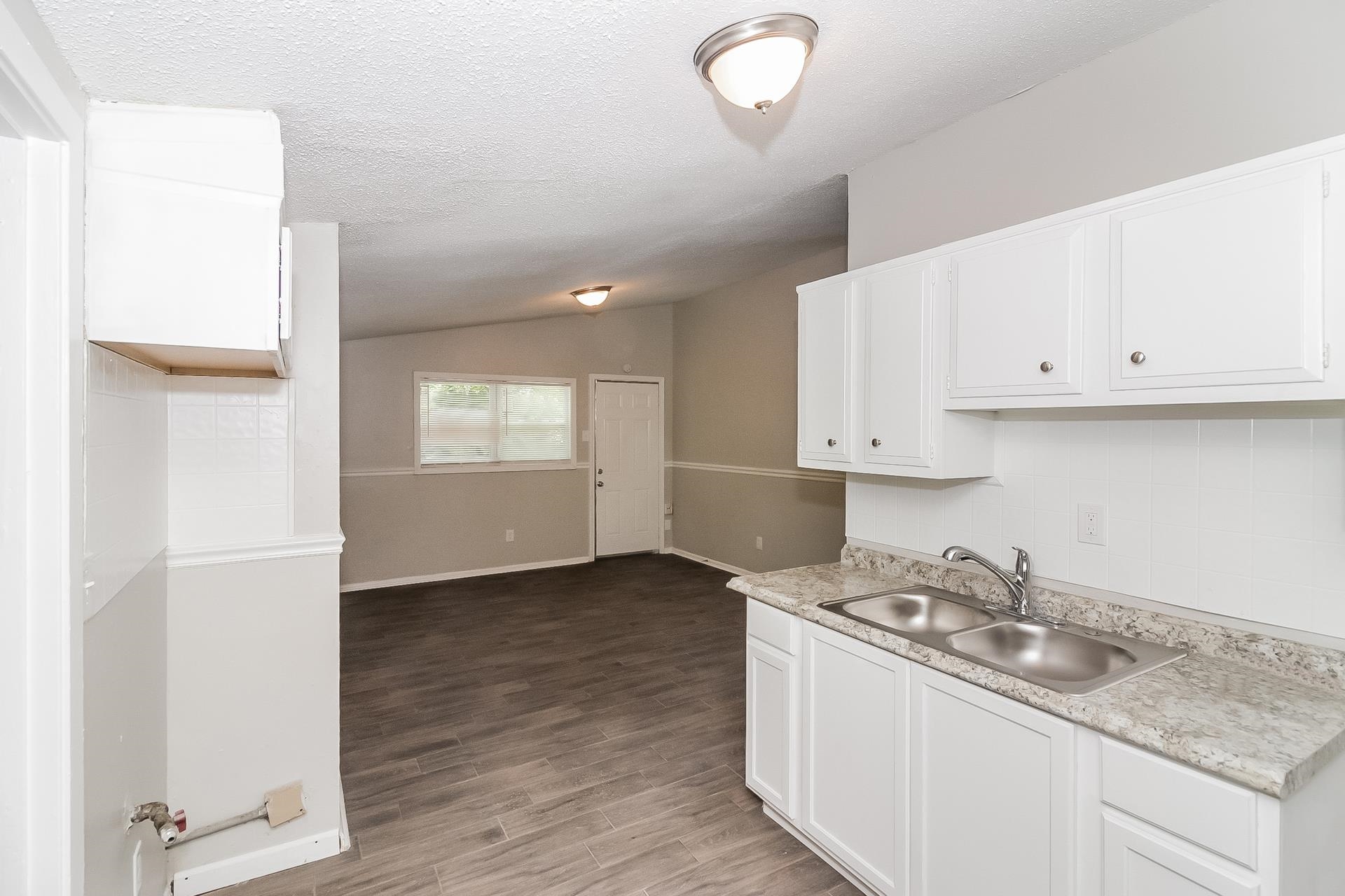 4217 Windermere Road Memphis, TN 38128 - Photo 6 of 15 a kitchen with granite countertop white cabinets and white appliances