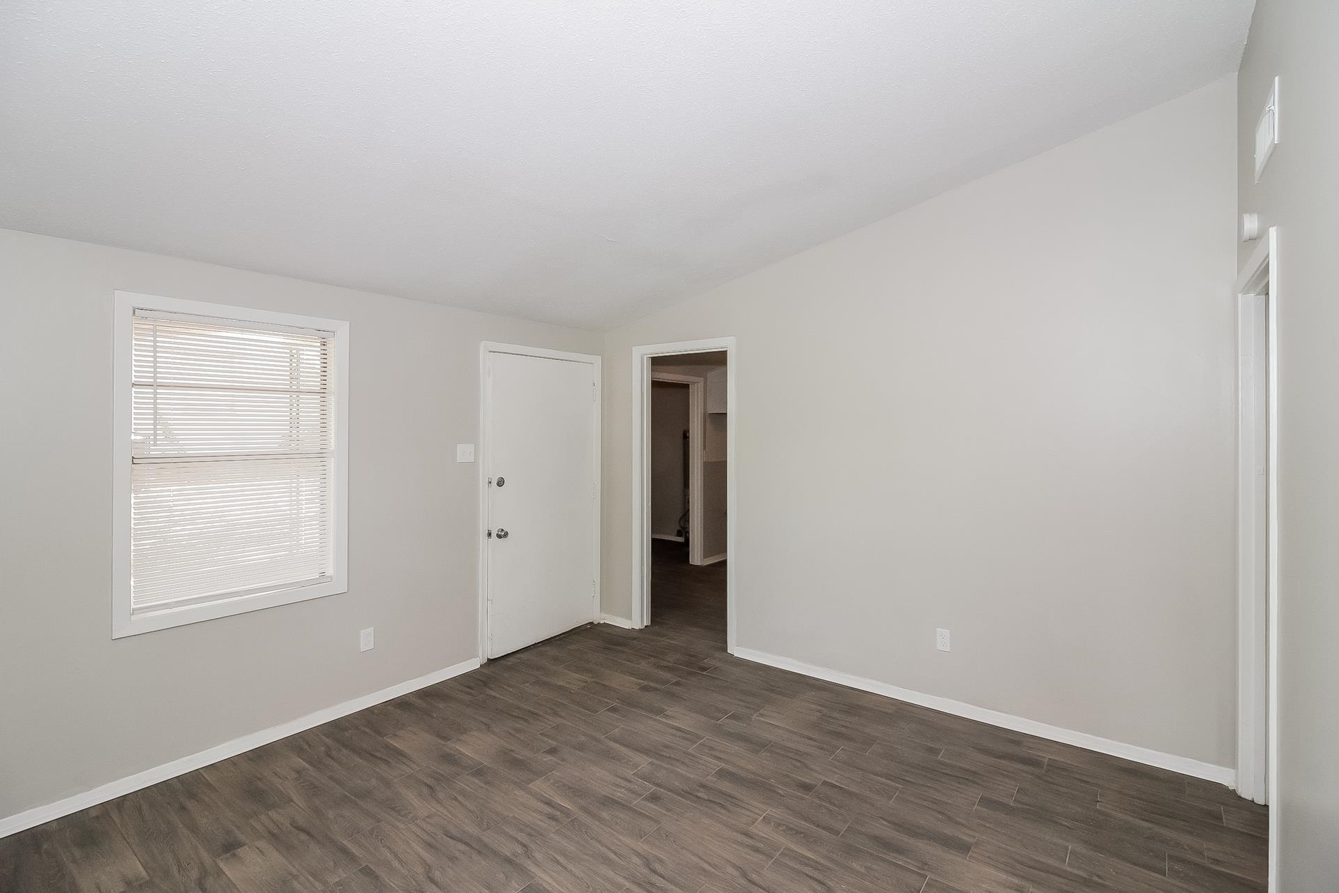 4217 Windermere Road Memphis, TN 38128 - Photo 7 of 15 an empty room with wooden floor and closet