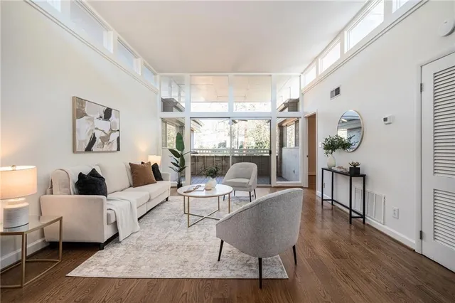 a living room with fireplace furniture and a large window
