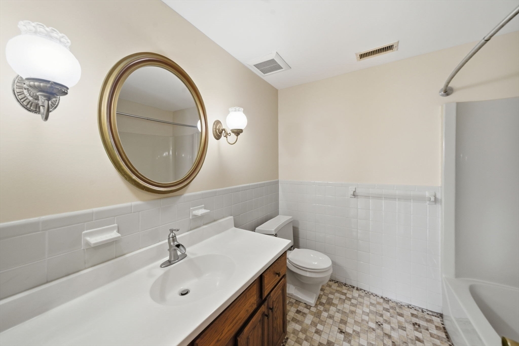 30 Conant Street, Unit 3B Beverly, MA 01915 - Photo 13 of 30 a bathroom with a sink a toilet and a mirror