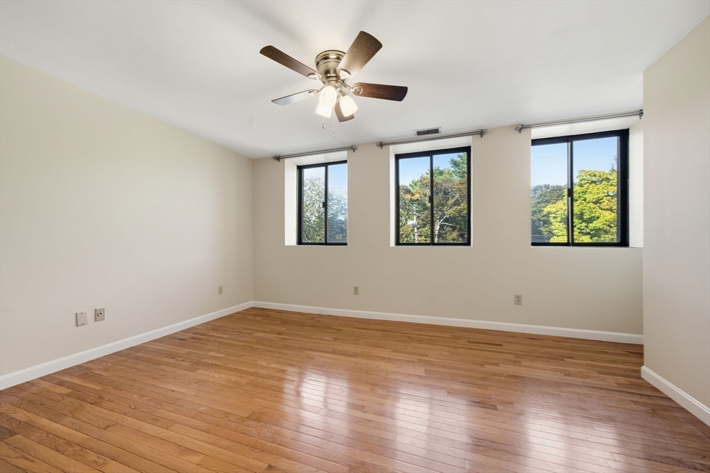 30 Conant Street, Unit 3B Beverly, MA 01915 - Photo 14 of 30 a view of an empty room with wooden floor and a window