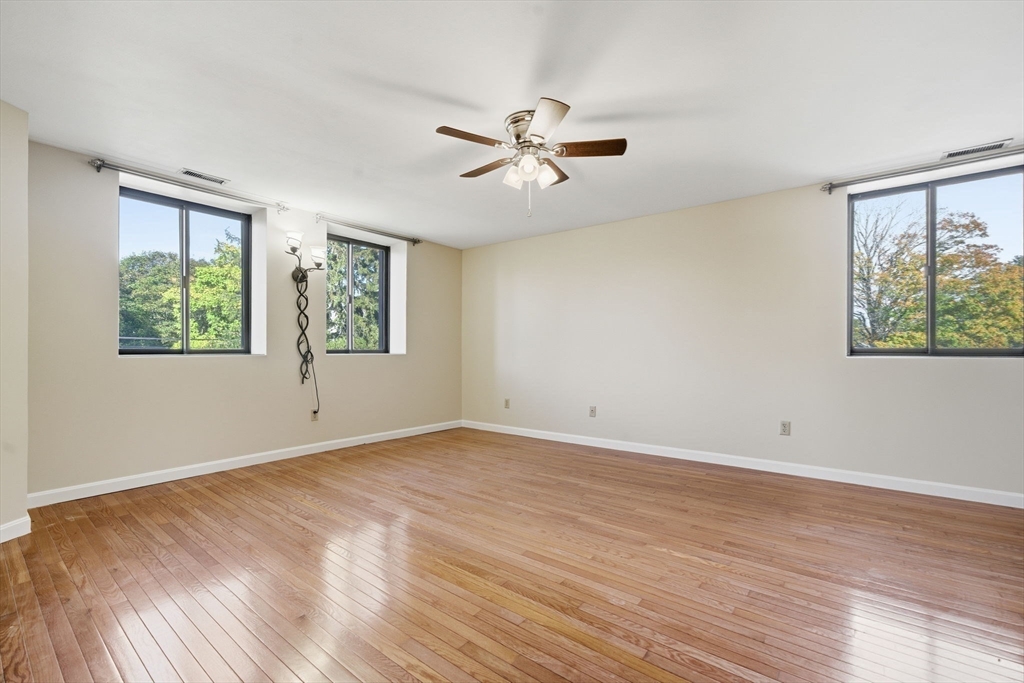 30 Conant Street, Unit 3B Beverly, MA 01915 - Photo 15 of 30 a view of empty room with wooden floor and fan