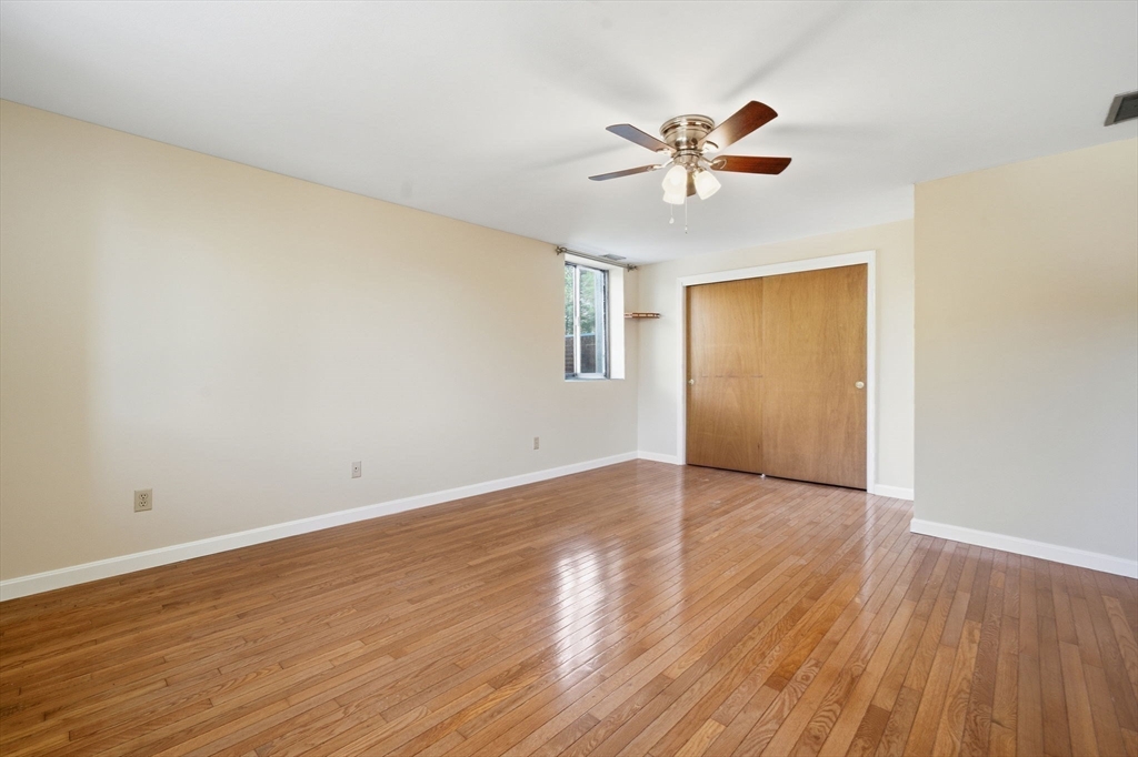 30 Conant Street, Unit 3B Beverly, MA 01915 - Photo 17 of 30 a view of an empty room with wooden floor and a ceiling fan