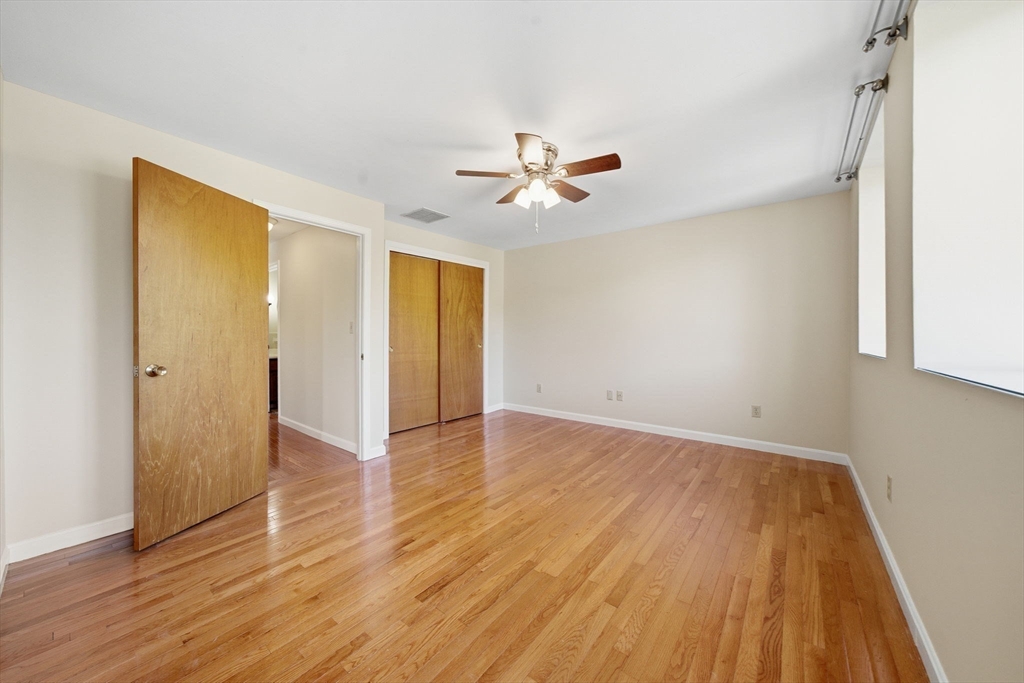 30 Conant Street, Unit 3B Beverly, MA 01915 - Photo 20 of 30 an empty room with wooden floor and a ceiling fan