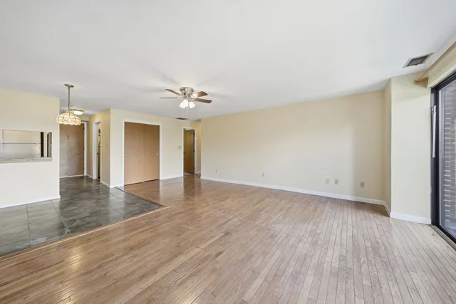 a view of an empty room and wooden floor