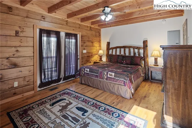 a bedroom with a bed next to a window