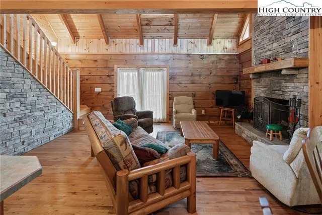 a living room with furniture a fireplace and a table