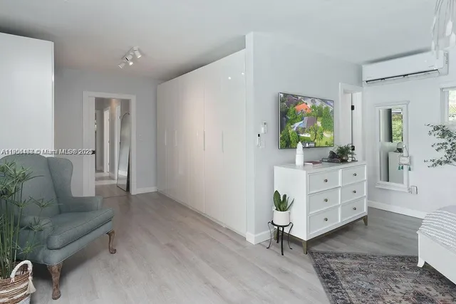 a living room with furniture and a entryway