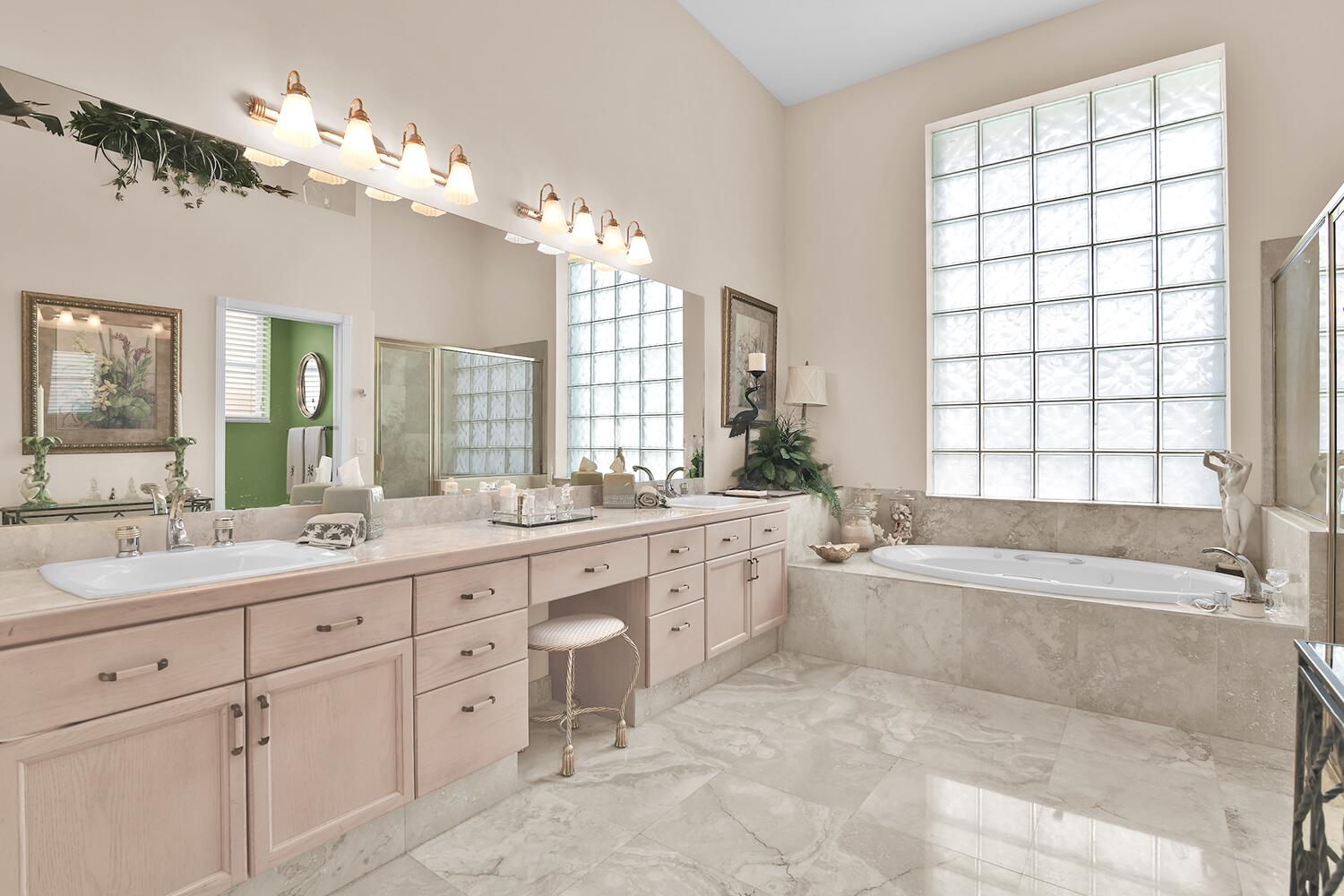 10721 St Andrews Road Boynton Beach, FL 33436 - Photo 15 of 27 a spacious bathroom with a granite countertop sink a large mirror a bathtub and next to a window