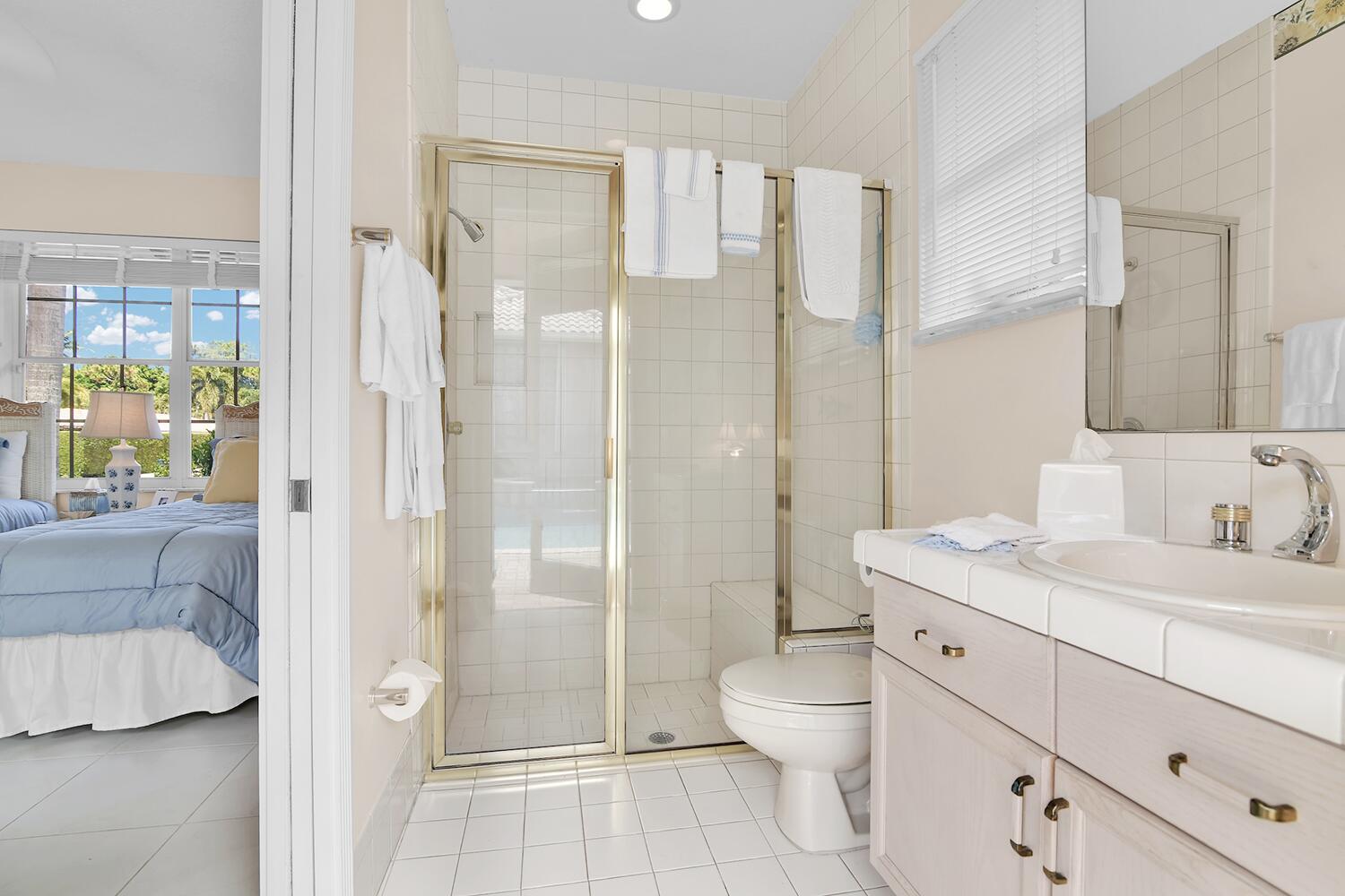 10721 St Andrews Road Boynton Beach, FL 33436 - Photo 19 of 27 a spacious bathroom with a double vanity sink toilet and shower