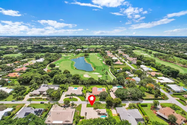 an aerial view of residential house with outdoor space and trees