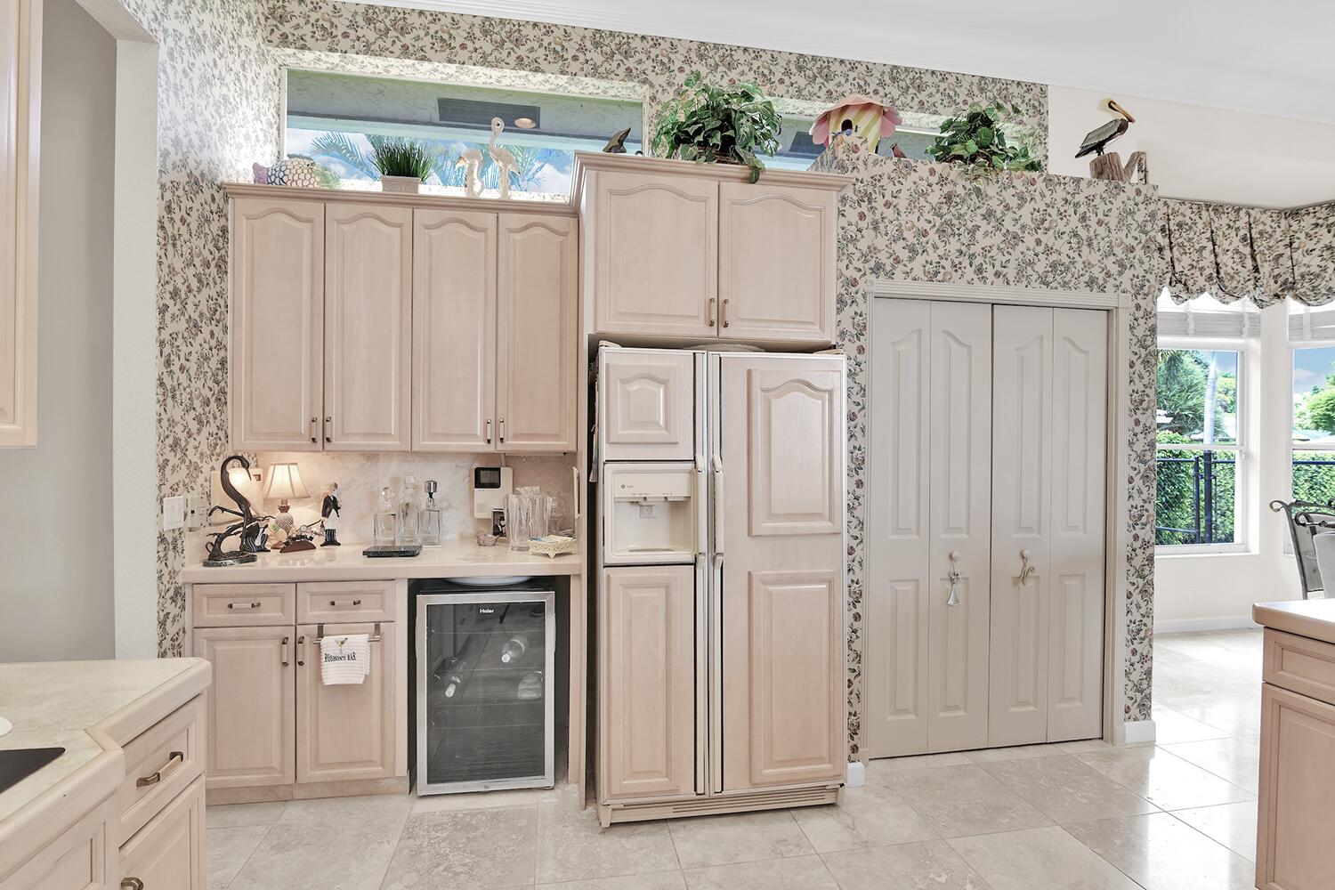 10721 St Andrews Road Boynton Beach, FL 33436 - Photo 7 of 27 a kitchen with stainless steel appliances granite countertop a sink stove and refrigerator