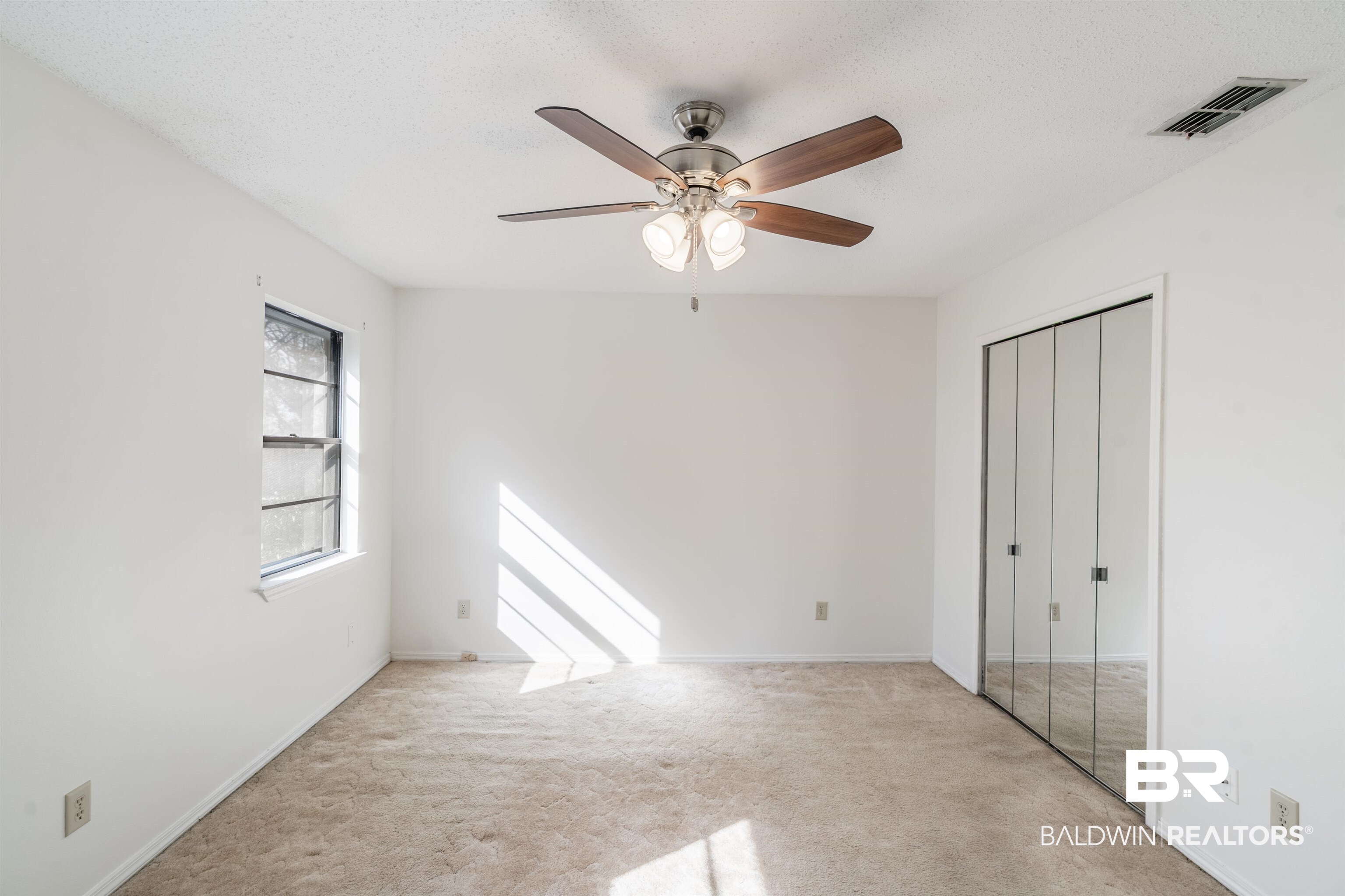 9751 Pine Knoll Road Mobile, AL 36608 - Photo 24 of 36 Unfurnished bedroom with ceiling fan, light carpet, a closet, and a textured ceiling