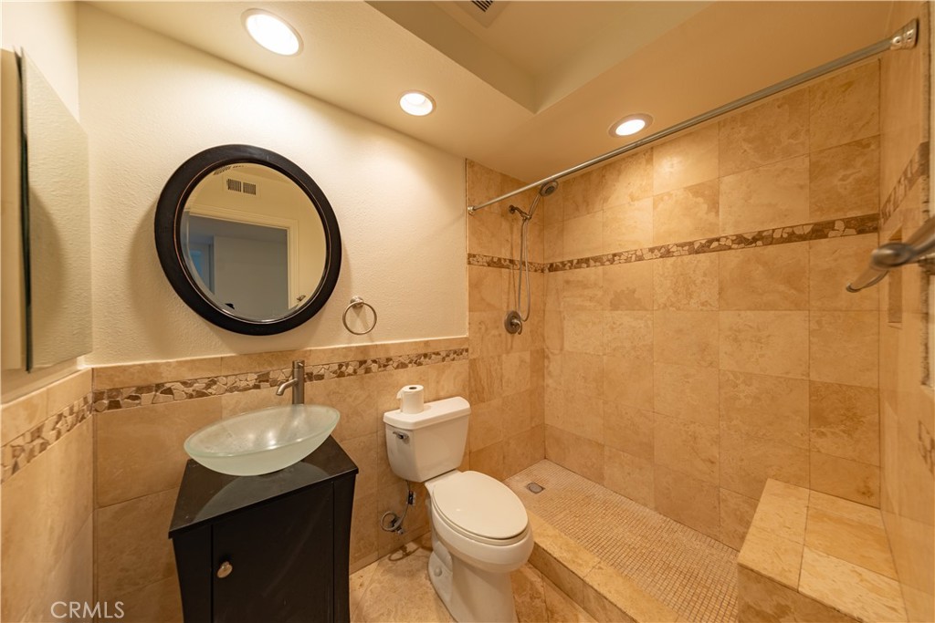 6242 Riviera Circle Long Beach, CA 90815 - Photo 12 of 29 a bathroom with a sink mirror vanity and toilet